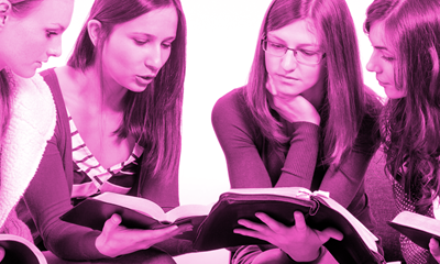 Two young women looking at a book