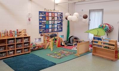 A playroom at Broadfield with play mat and toys