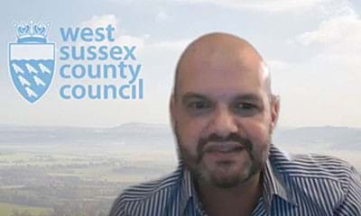 Andrew in front of a council backdrop