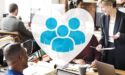A busy diverse office environment with smiling people and a graphic overlay on the image representing people.
