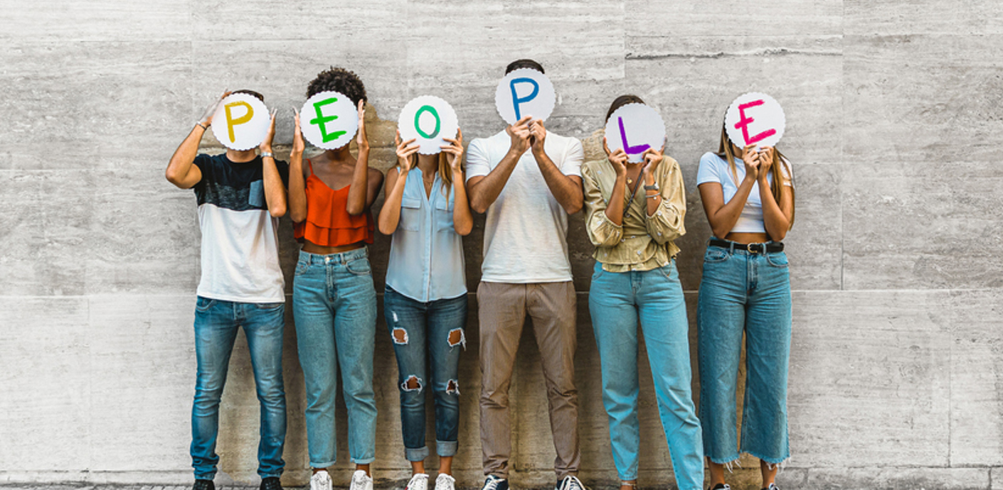 nojs Six individuals each holding a card in front of their face that together spells people.