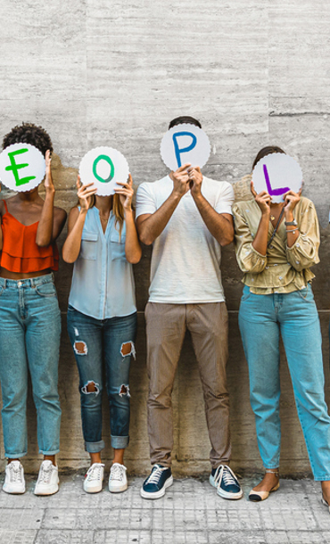 Six individuals each holding a card in front of their face that together spells people.