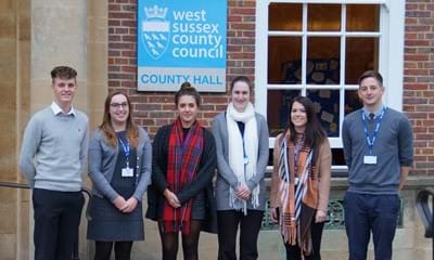 Young people standing outside West Sussex County Hall