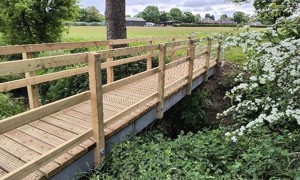Photo of new wooden bridge on countryside walking route
