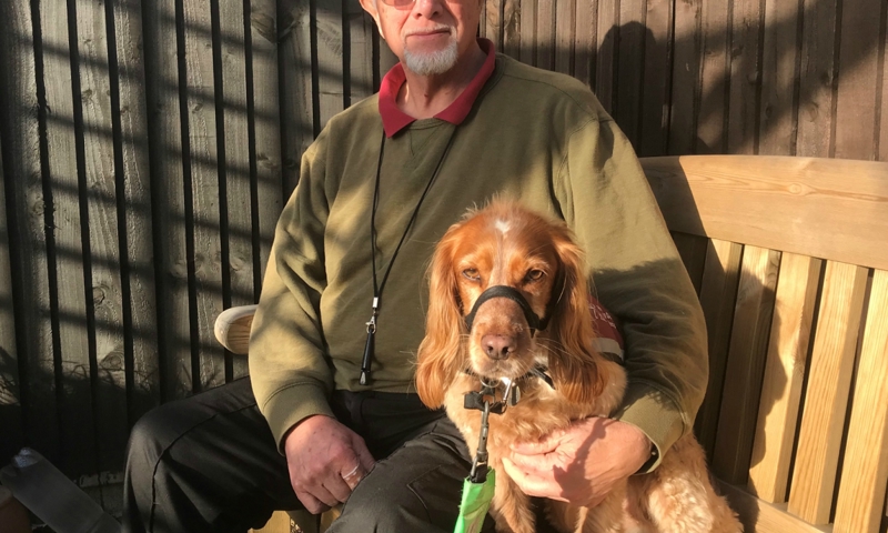 Chris Clow and Belle sat on a bench