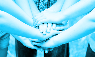 A group of people with entwined hands