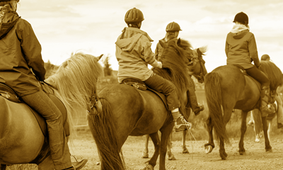 A group of people riding horses