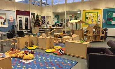 Social area including play mat, toys and seating