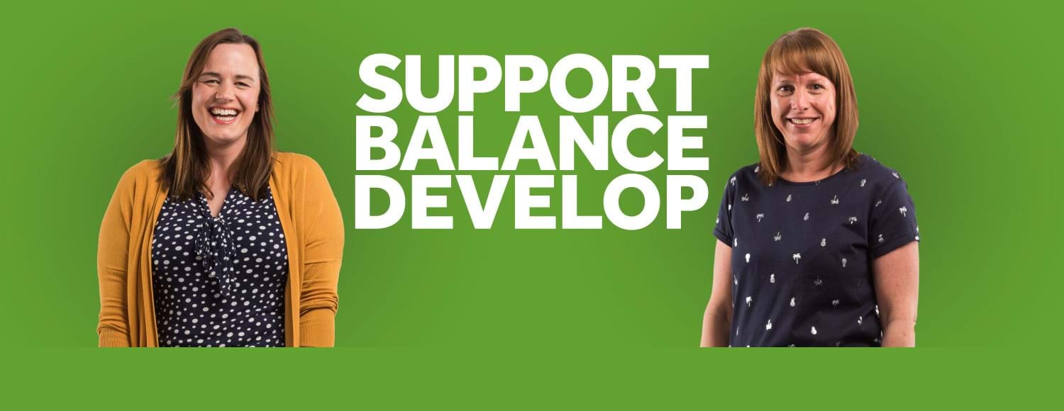 Two women outside 'Support, Balance, Develop' logo