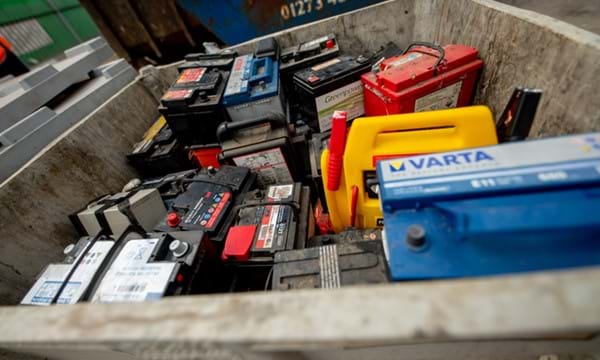 Car batteries in a container at a recycling centre.