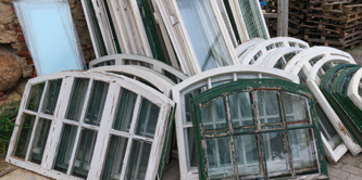 A number of window panes stacked against each other.