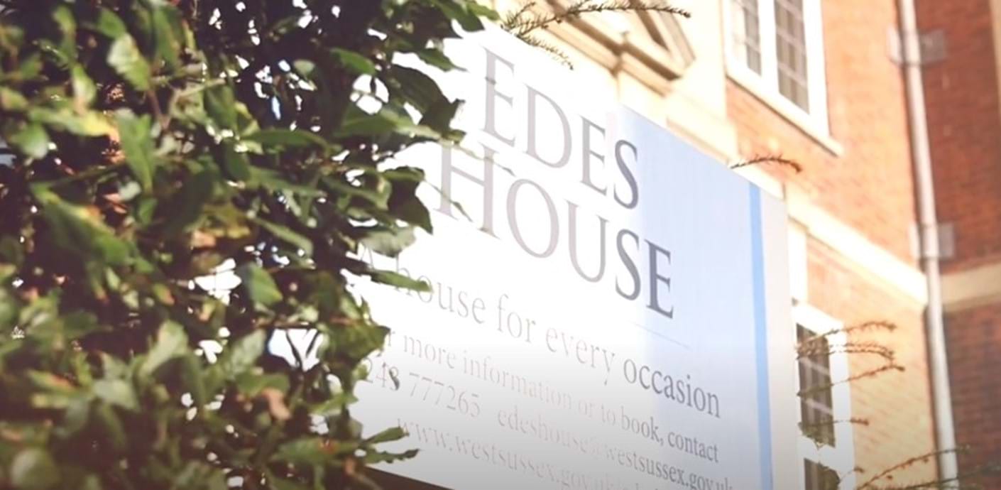 Edes House sign and part of the building shaded by a tree
