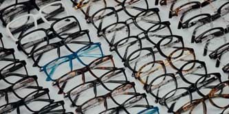 Pairs of spectacles laid out in 4 diagonal lines.