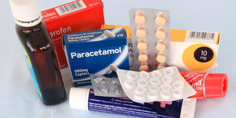 Various types of medicine packaging, including tubes, a bottle and blister packs.