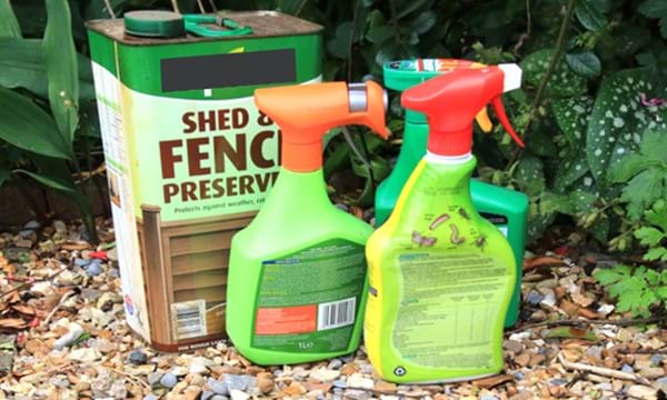 Garden chemicals in cans and spray bottles.
