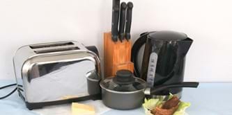 Items of kitchen waste - food, old saucepan, kettle, toaster.