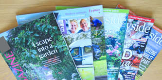 6 magazines fanned out on a table.