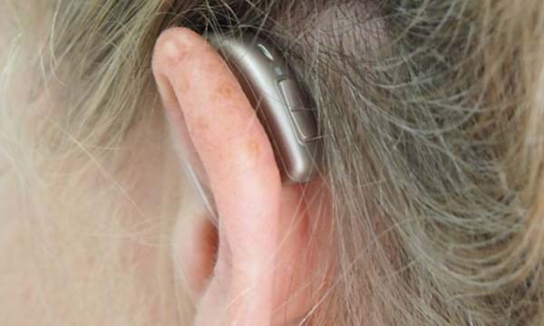 A woman wearing a hearing aid.