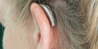 A woman wearing a hearing aid.