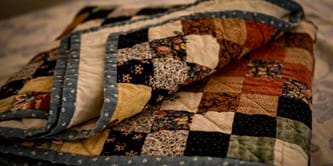 A folded patchwork quilt.