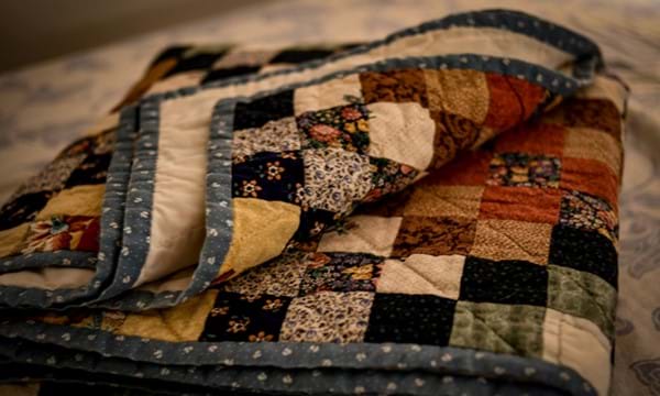 A folded patchwork quilt.