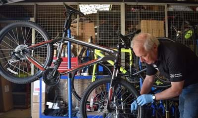 Martin Child, a Bikeability instructor, renovates an abandoned bicycle provided by Southern Rail and destined to be donated to an NHS worker