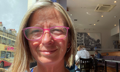 Caroline standing at a sunny window