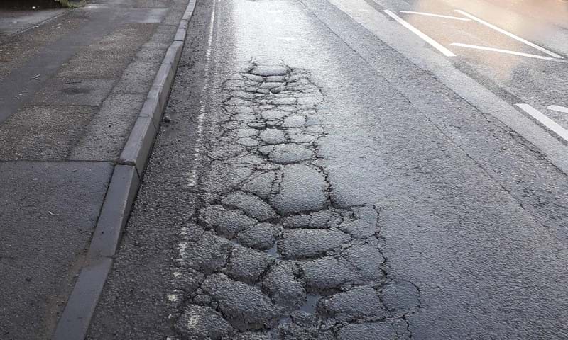 Picture of road surface with damage to tarmac