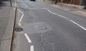 Cracked and broken tarmac in Poulters Lane, Worthing