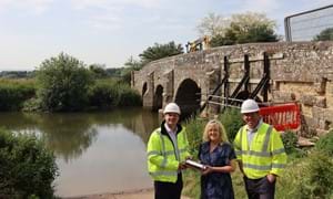 Pictured on the slipway beside the ancient bridge are (from left) Michael Taylor, the County Council’s Engineering Project Manager, business owner Helen Johnson with the capsule, and Richard Finn, Director of Principal Contractor Landbuild