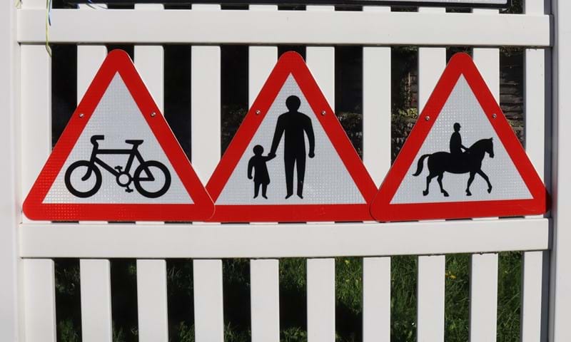 Close-up of signs: Speed limit policy changes in West Sussex will help vulnerable road users, such as cyclists, pedestrians, and equestrians