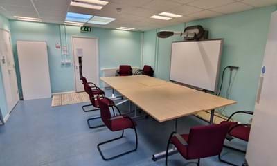 Meeting room showing table and chairs and interactive whiteboard