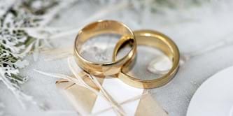 Two gold rings on a decorative background. 
