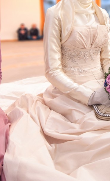 People, including a bride, at an Islamic marriage ceremony.