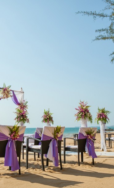Wedding arch, aisle and chairs on an exotic beach.