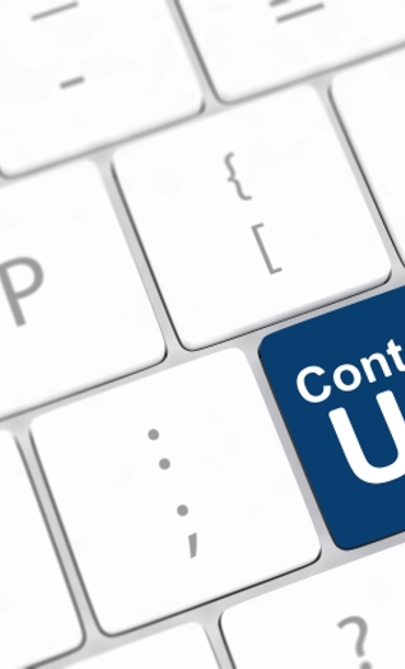 White keyboard with a key highlighted in blue that reads 'contact us'.