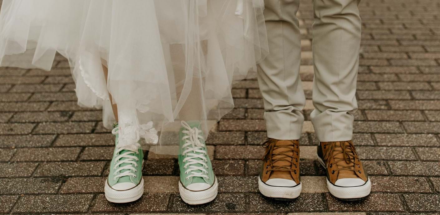 nojs Couple in wedding outfits with trainers.