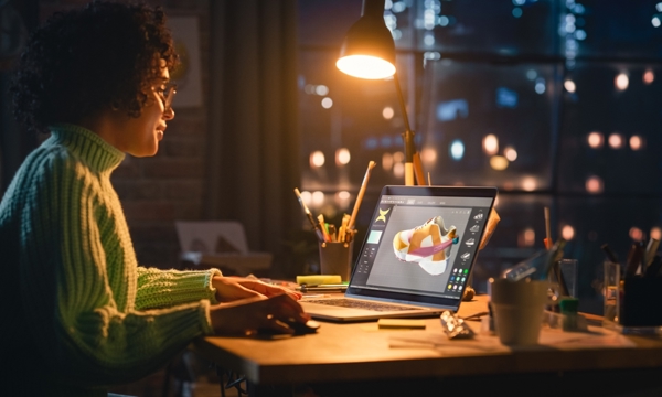A person working on a laptop in the dark