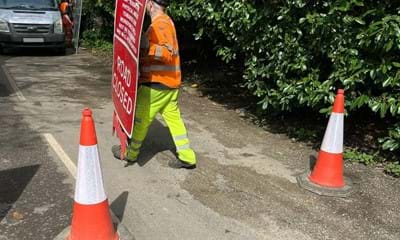 Signs and barriers being removed at West Chiltington Road