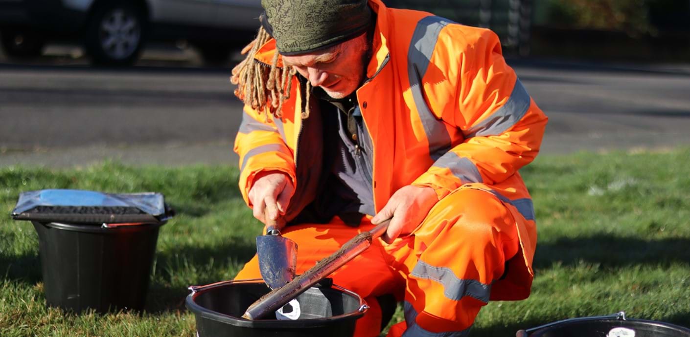 nojs Man collecting soil samples
