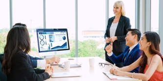 4 people looking at a screen