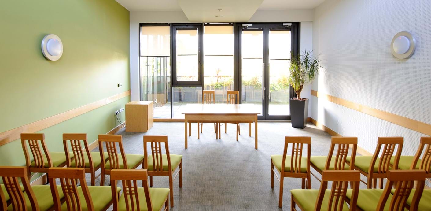 nojs Chairs laid out in a bright, modern room facing glass windows and doors