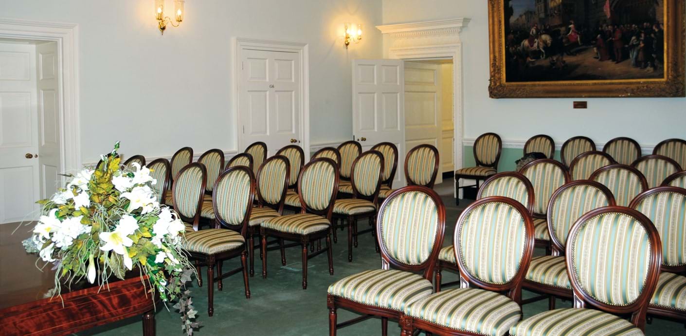 nojs Elegant ceremony room with chairs laid out and large painting in the background