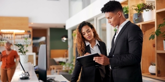 A man and woman looking at a clipboard