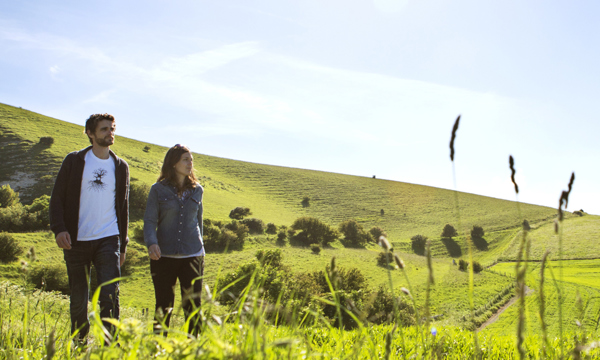 Couple walking through countryside