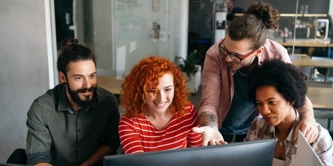 A group of people looking at a computer