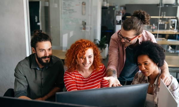 A group of people looking at a computer