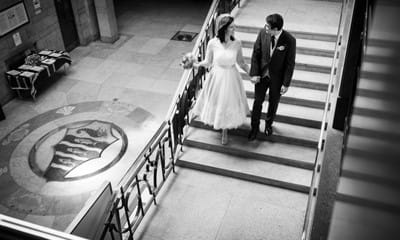 Black and white photo of couple on staircase