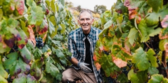 A man stood within the vines