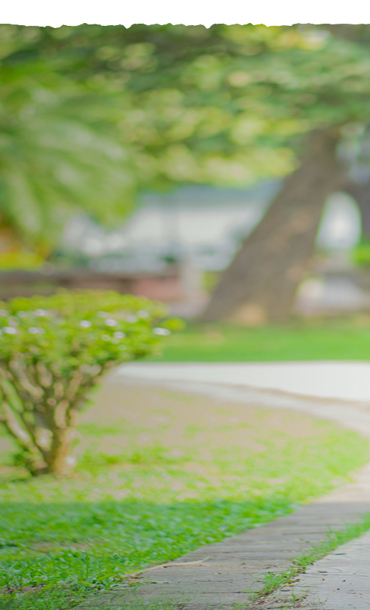 A young man taking a breather while exercising in a park.